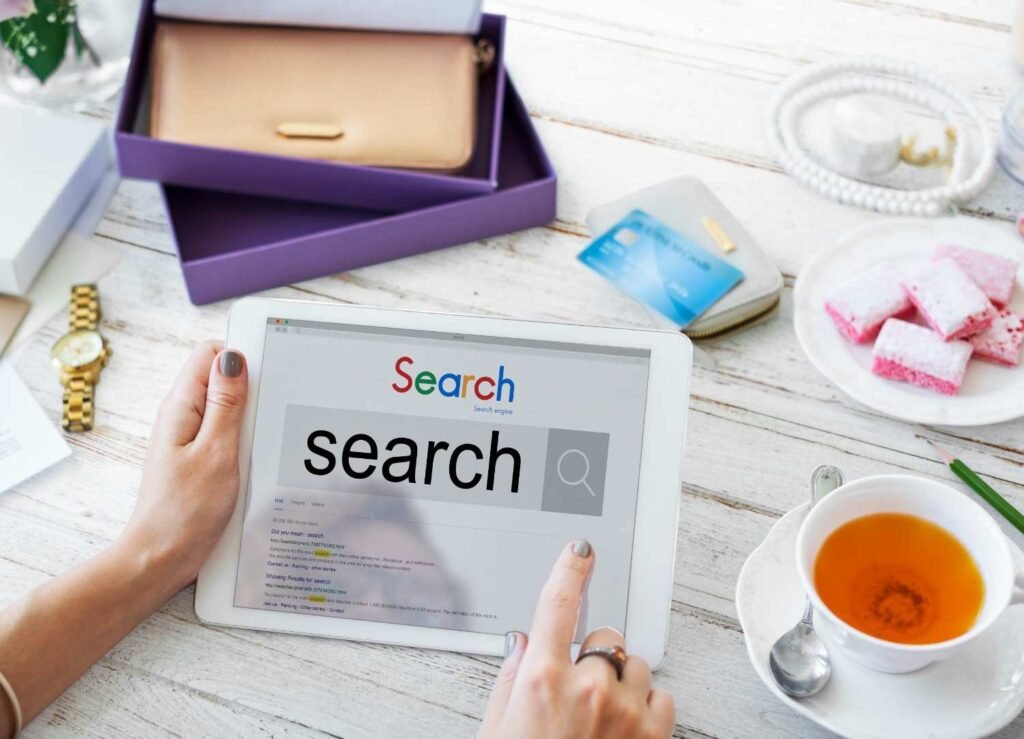 A woman holding an I Pad with search interface open, showing search system.