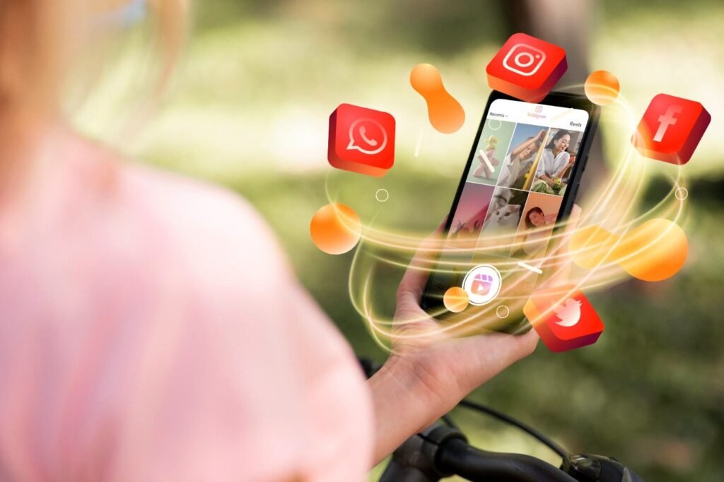 A man hand holding smartphone with social media icons graphics.
